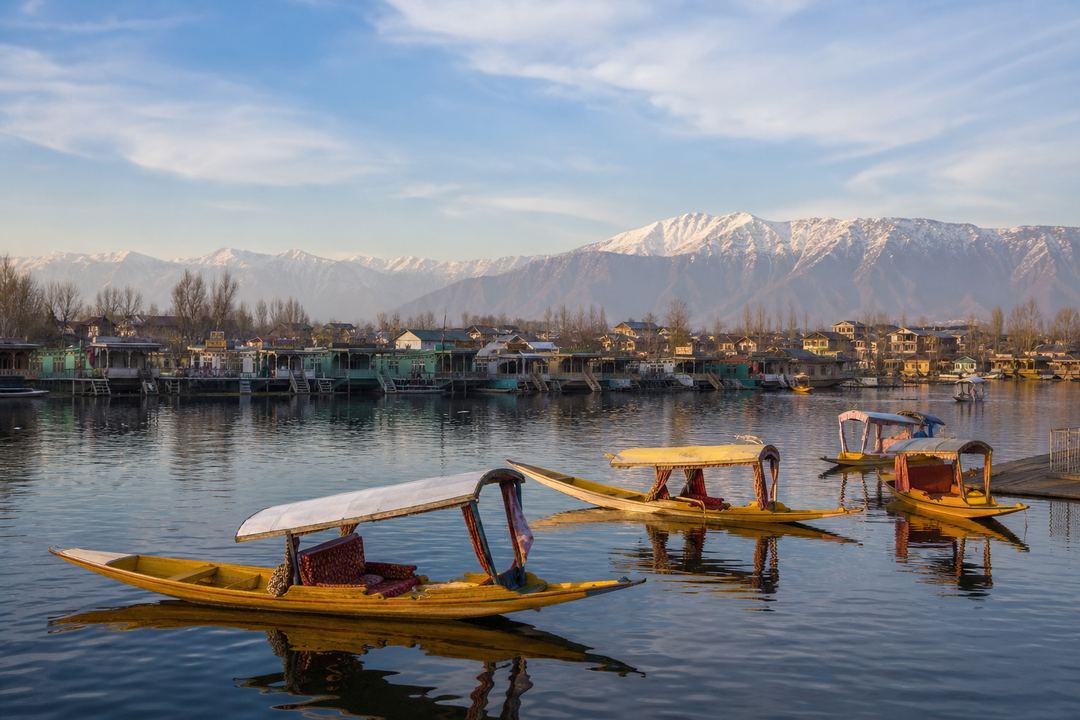 Shikaras on Dal Lake in Srinagar with houseboats and mountains in the background