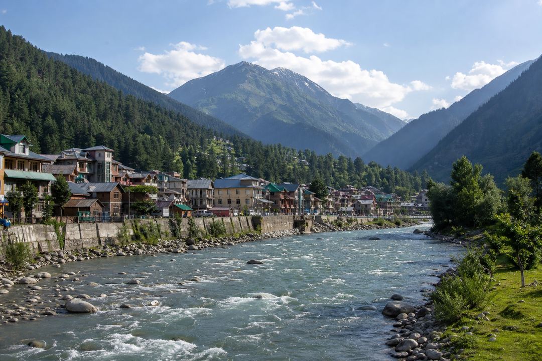 View of Pahalgam town in the Lidder Valley with the Lidder River, pine forests and surrounding mountains.