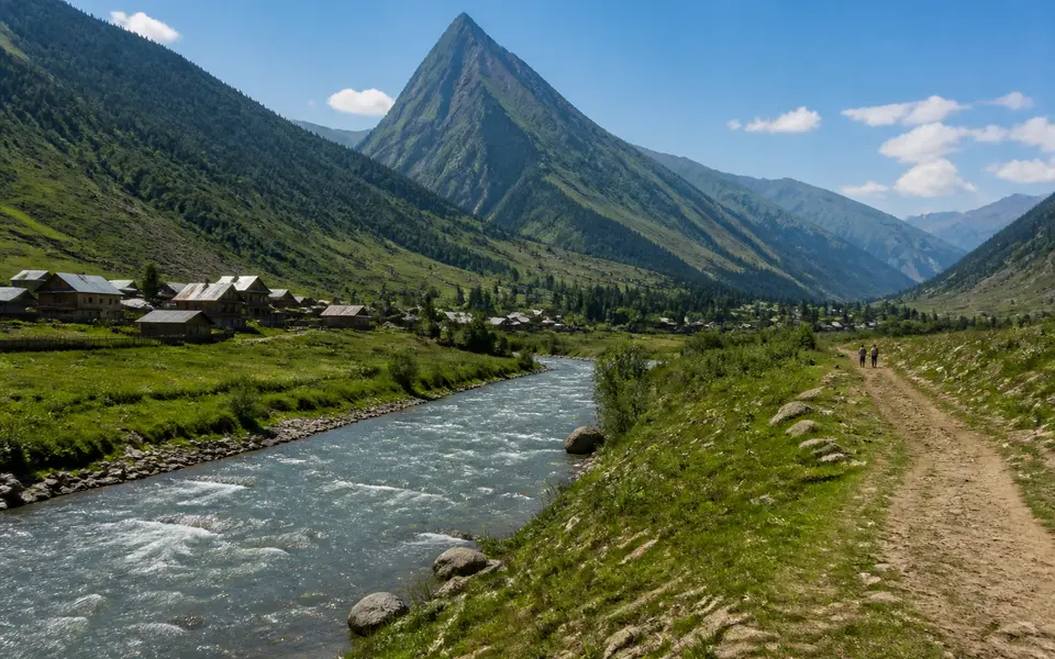 Wide view of Gurez Valley in summer with the Kishanganga River, green slopes and a sharp peak resembling Habba Khatoon.